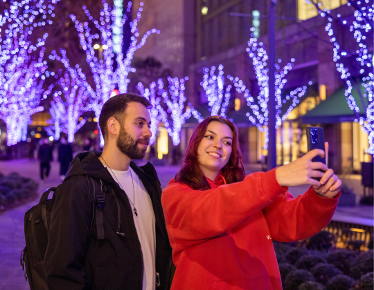 couple taking a selfie with christmas lights in japan